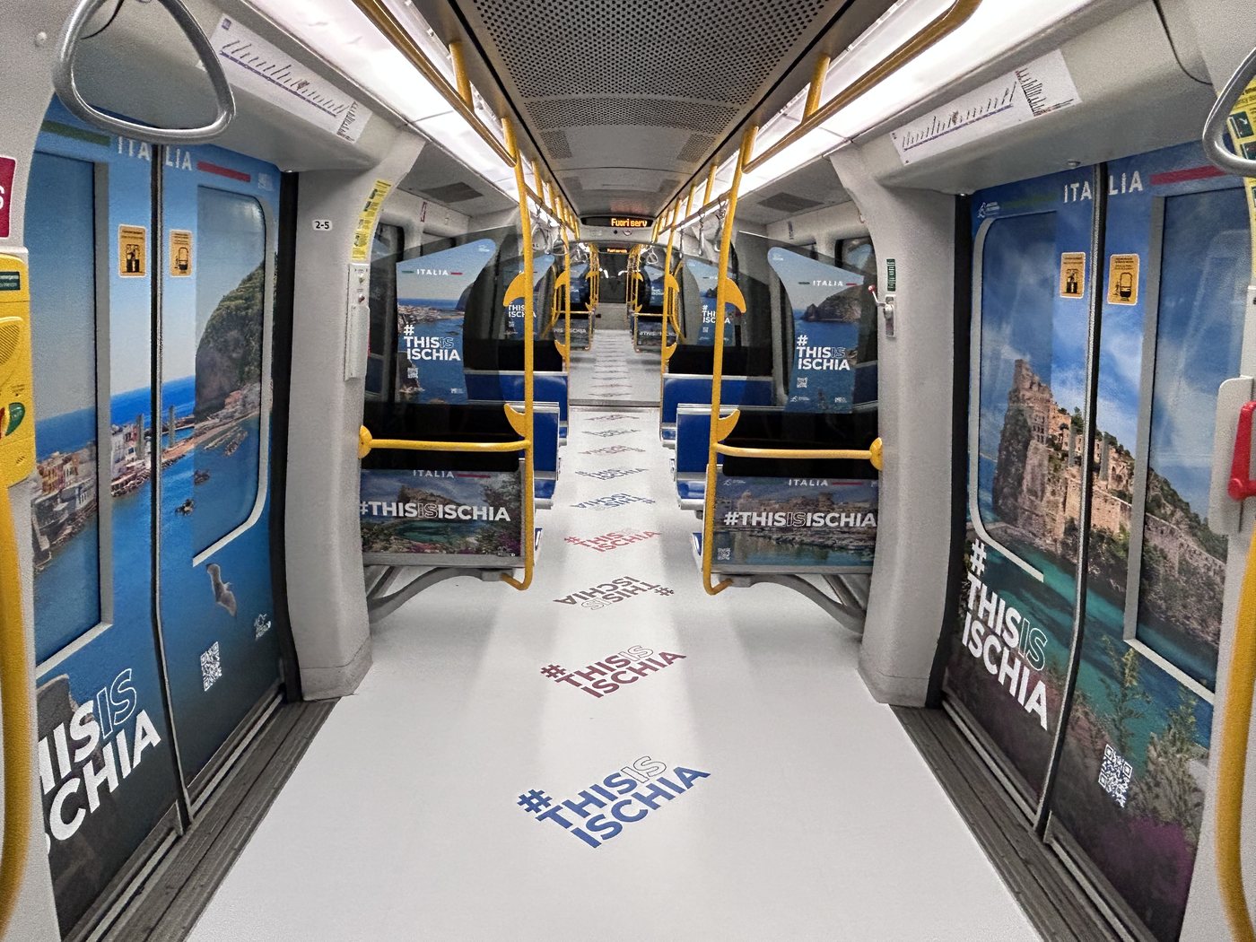Treno M5 vestito interamente con la campagna #THISISISCHIA — paesaggi blu del Mediterraneo, scogli e mare